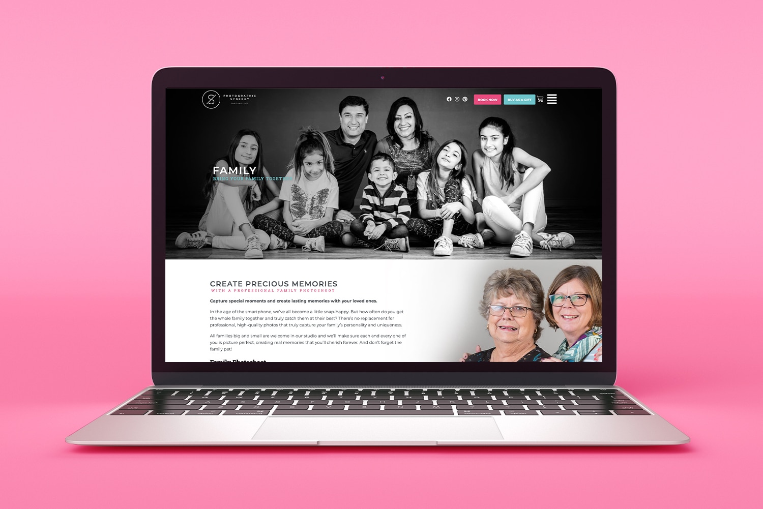 A laptop displaying a photography studio website on its screen, set against a pink background. The site features a black and white image of a smiling family and a section about capturing family memories. Below the text, there are two smaller photos of two elderly women.